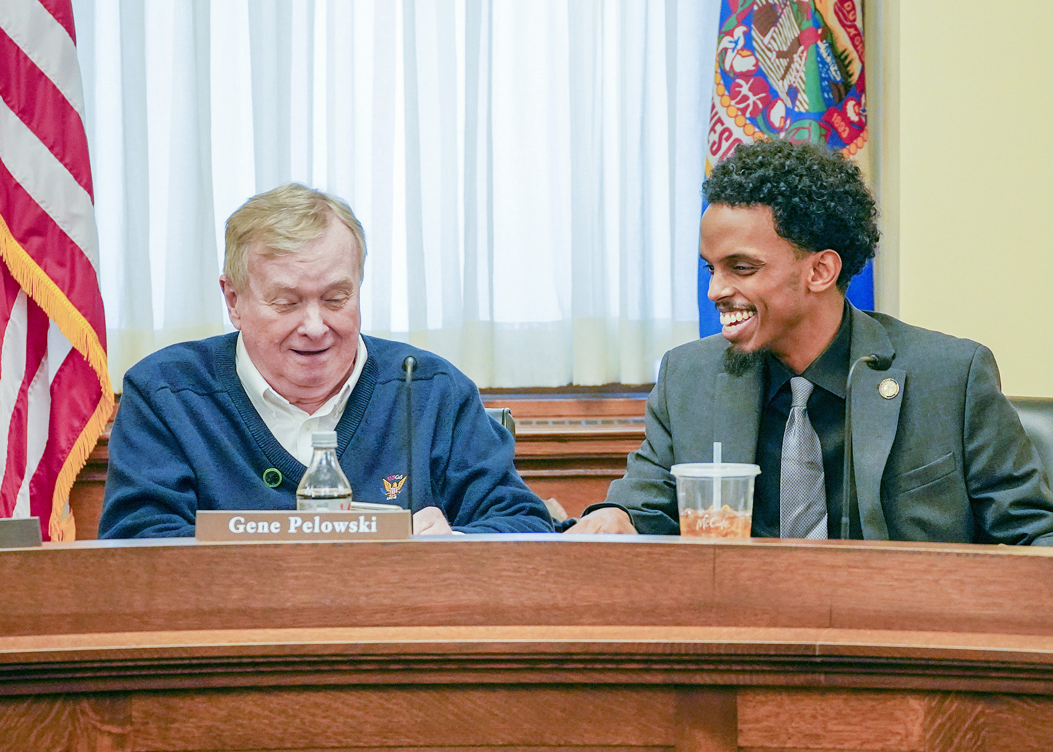 Rep. Gene Pelowski, Jr. and Sen. Omar Fateh confer before Wednesday’s first meeting of the higher education conference committee. (Photo by Andrew VonBank)